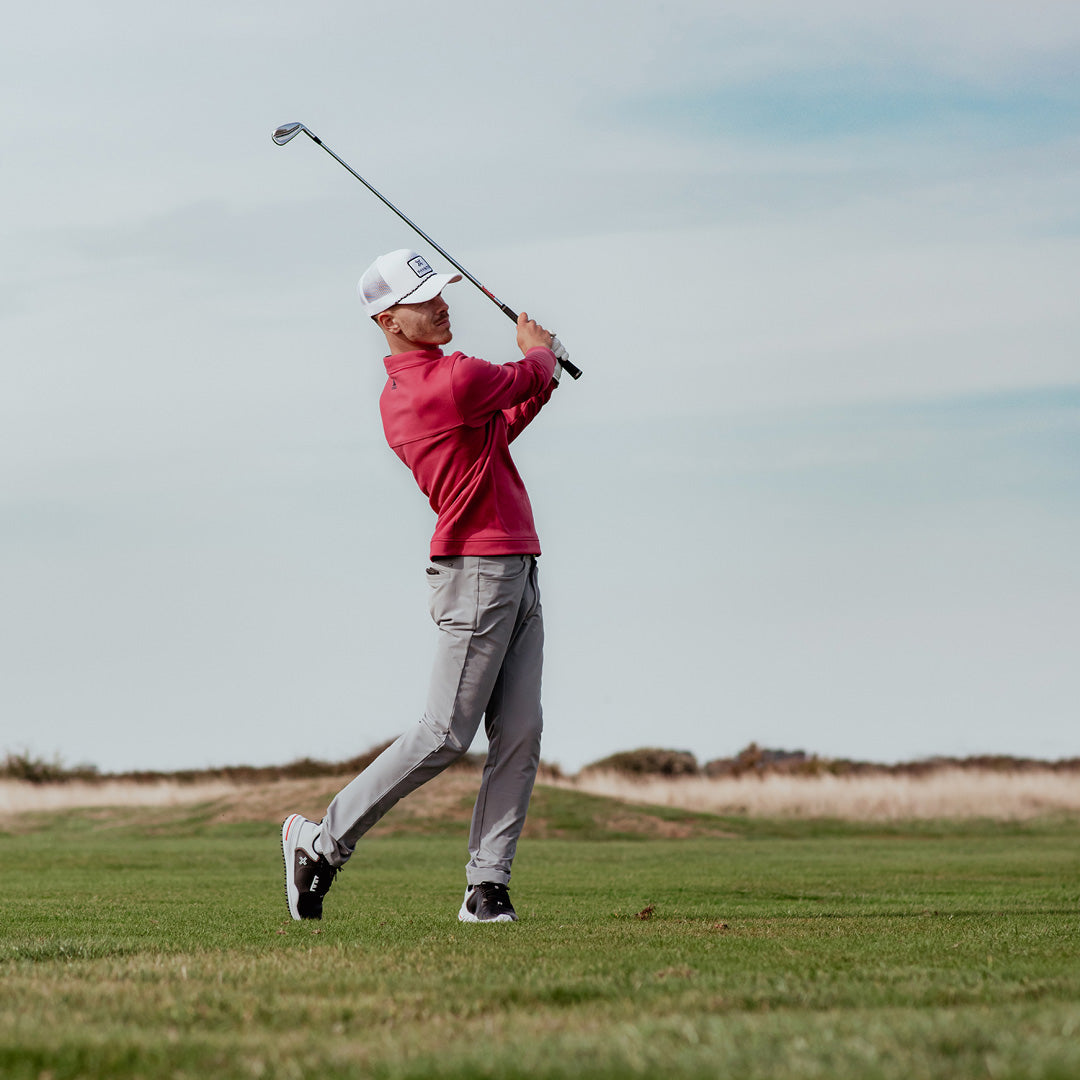 Golfer hitting a golf ball with an iron whilst wearing the PAYNTR X-003 F Spikeless Golf Shoes